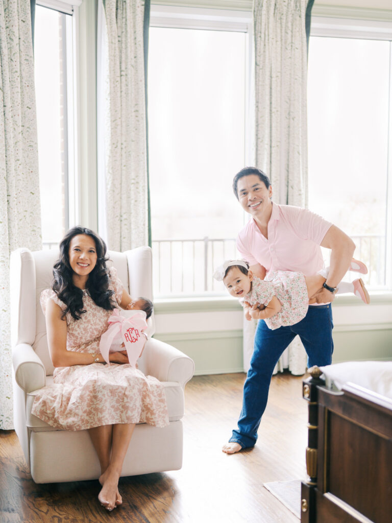 Lifestyle in-home newborn photography with family in nursery