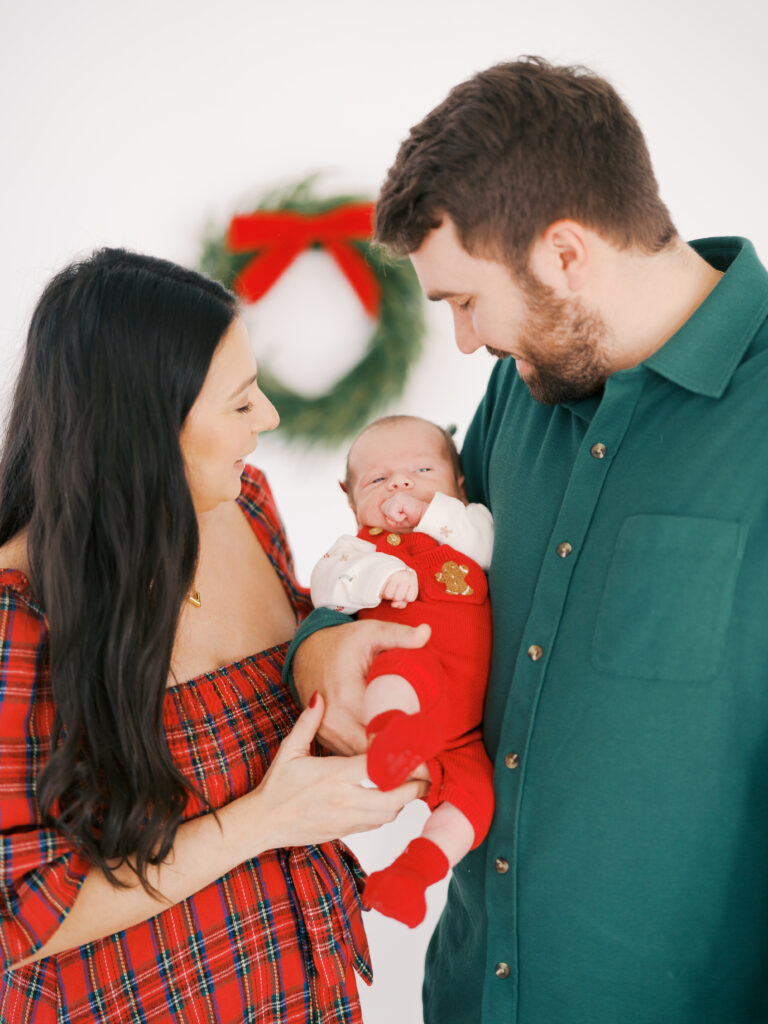 mom, dad and baby during holiday photos
