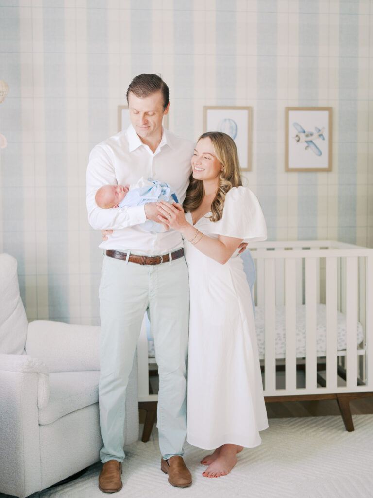 mom and dad holding their newborn baby boy during in home newborn session