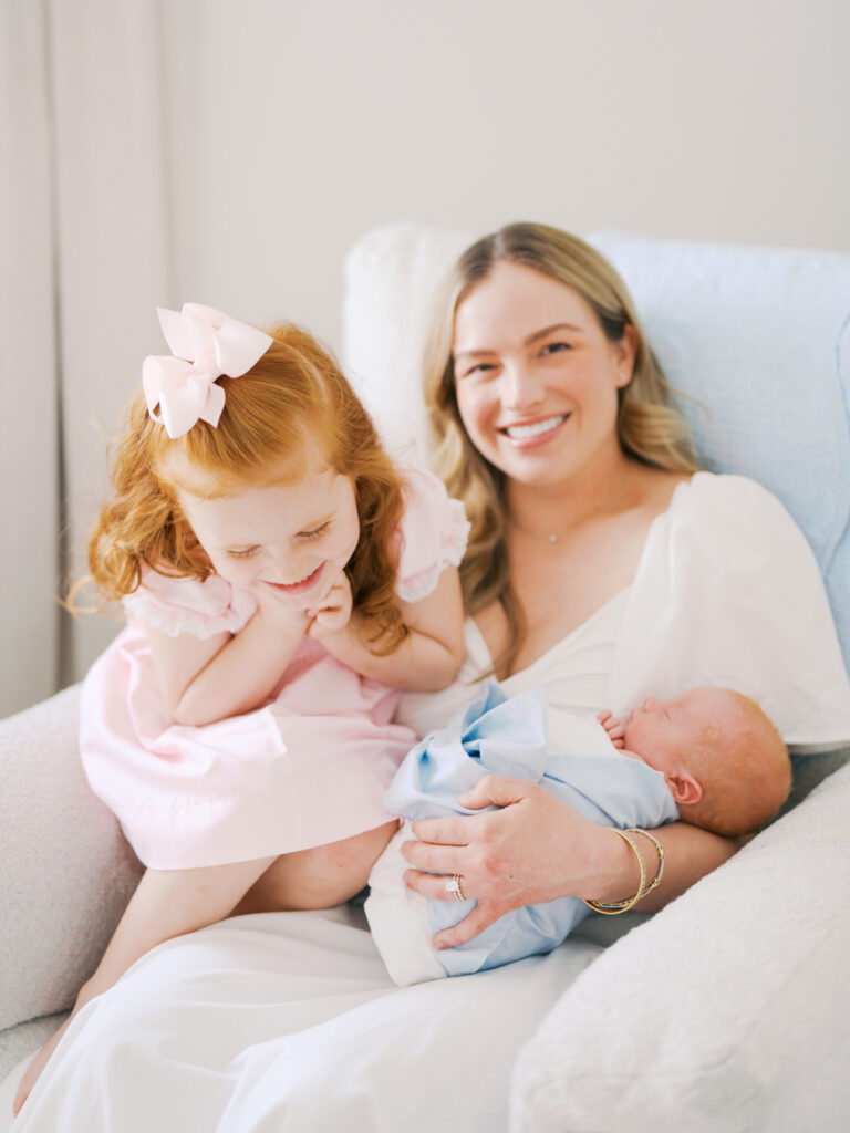 mom sitting in chair with baby boy and toddler girl