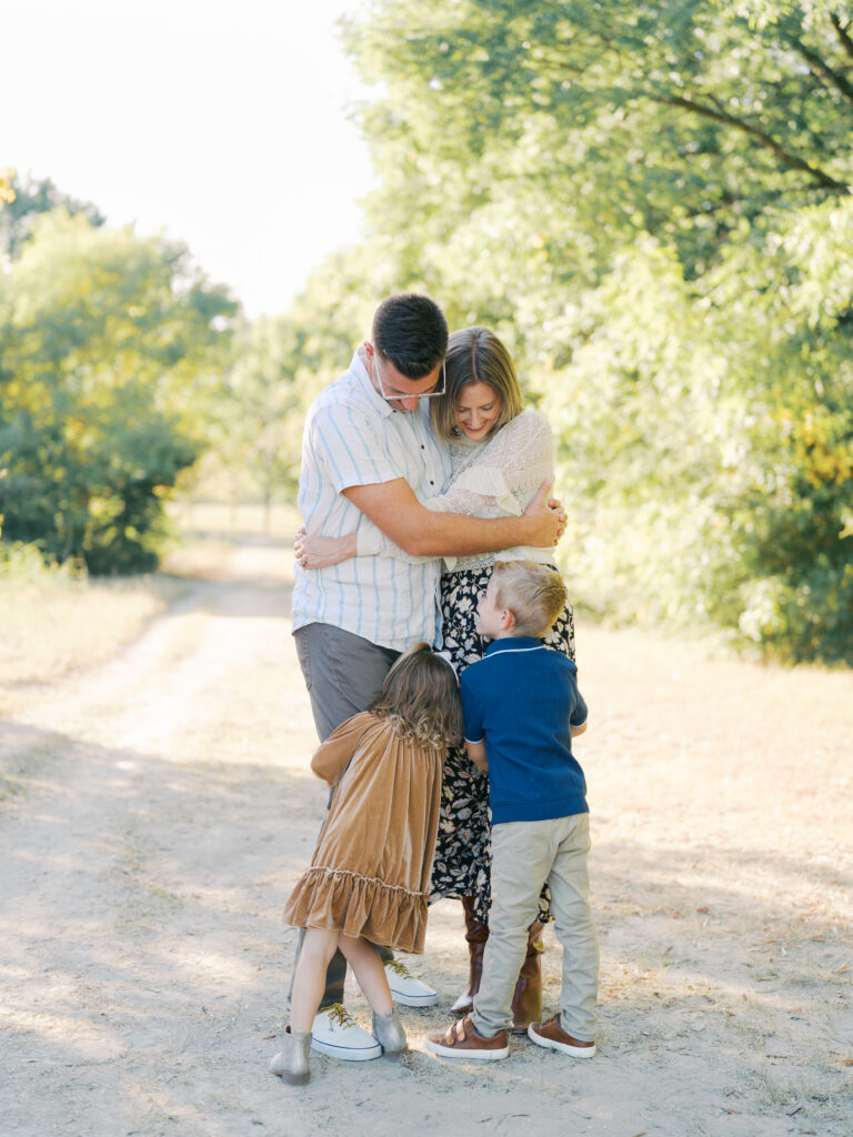 family of four hugging