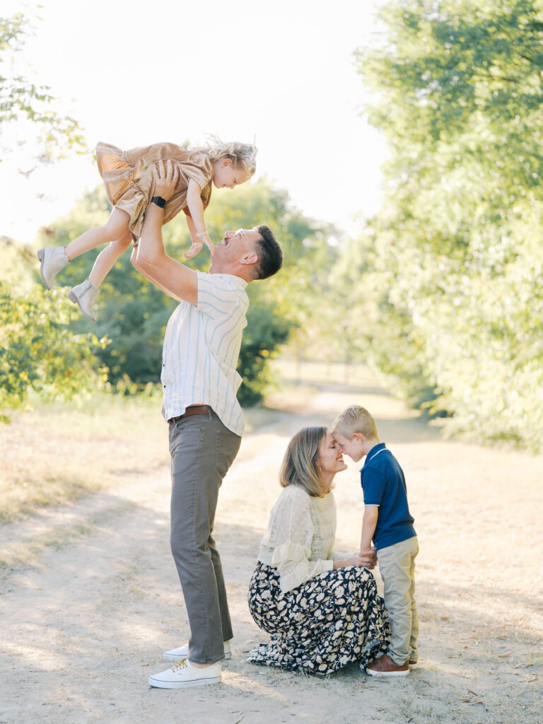parents and kids playing together during family session in dallas